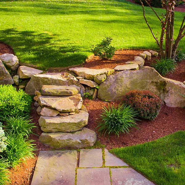 Well landscaped rock stairs and rock wall
